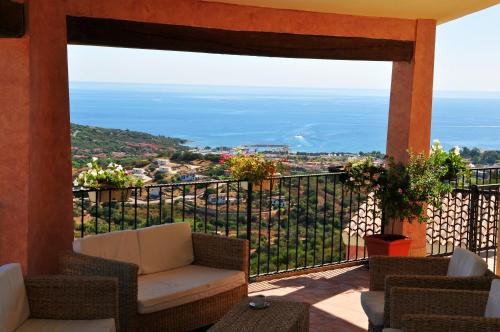 a balcony with a couch and a view of the ocean at Hotel Castello Budoni in Budoni