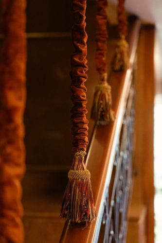 a row of wooden shelves with broomsticks on them at Le Cedrus Hotel in Al Arz