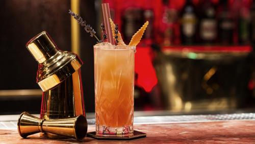 a drink sitting on a bar with a bottle of drink at 236 ROOMS Wörthersee - Adults Only & Self Check-in in Krumpendorf am Wörthersee
