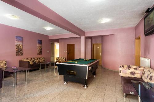 a billiard room with a pool table and couches at Hotel Brod - Free Parking in Sofia