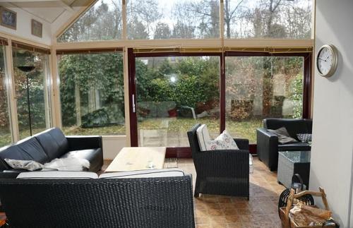 a living room with a couch and chairs and a table at Natuurhuis Drents-Friese Wold in Zorgvlied