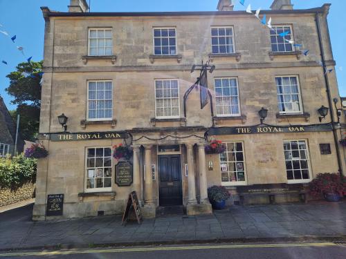 an old stone building with the royal oak at The Royal Oak in Corsham