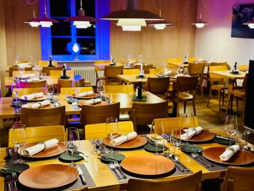 a dining room with wooden tables and chairs at Gasthaus Hirschen Mandach by perfect lifestyle in Böttstein