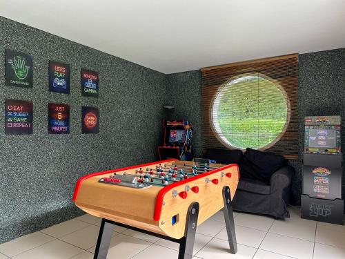 a room with a table with a chess board on it at Villa avec piscine, Cinéma, terrain privé in Nogent-le-Phaye
