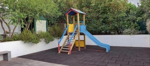 a playground with a slide and a ladder at Apt Mossbrae-tavira Centre, Terrasse Et Piscine in Tavira