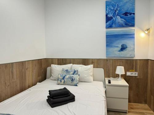 a bed with white sheets and pillows on it at Rodrigues 15 in Valencia