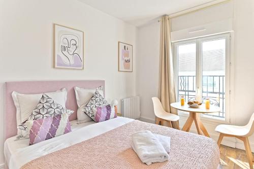 une chambre avec un lit, une table et une fenêtre dans l'établissement Magnifique studio neuf au centre de Montreuil - II, à Montreuil