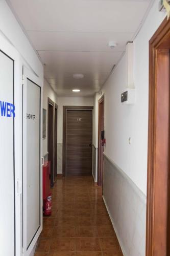 a hallway leading to a room with a door at Tempi Hotel in Athens