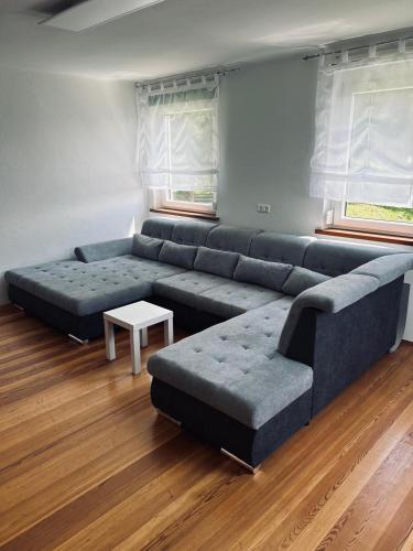 a living room with a large couch and a table at Fuchsbau in Vordertheissenegg