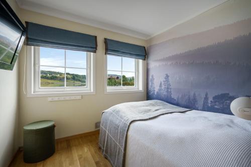 En eller flere senge i et værelse på Cozy modern apartment - Very central at Sinnes