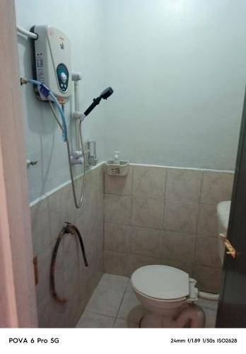a bathroom with a shower and a toilet in it at Resort Iman D'Semungkis in Hulu Langat