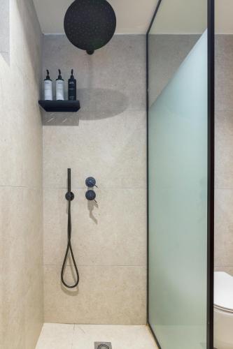 a shower with a glass door in a bathroom at Maison Muse in Hydra