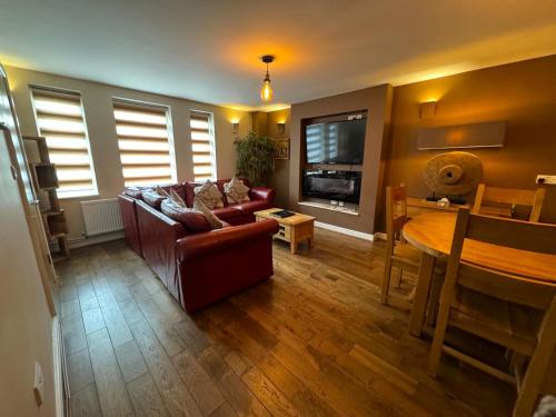 a living room with a couch and a table at The Jewellery Suites Birmingham in Birmingham