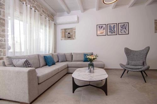 a living room with a couch and a table at Mirabilia Family House in Pitsidia