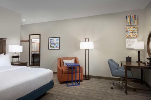 a hotel room with a bed and a desk and a chair at Hampton Inn & Suites Huntsville Research Park Area in Huntsville