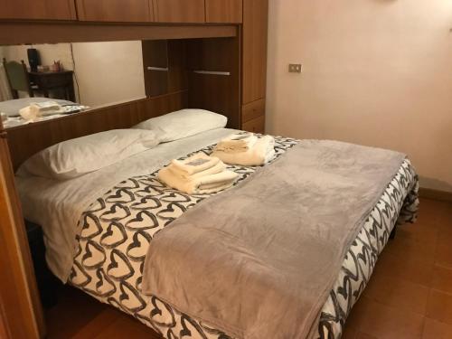 a bedroom with a bed with two towels on it at The sweet Frascati Home in Frascati