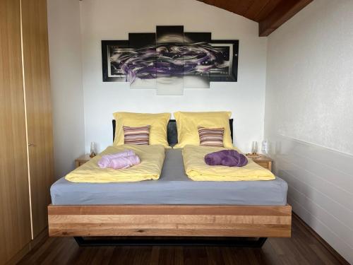 a bed in a room with two pillows on it at Herzogberghof in Kindberg