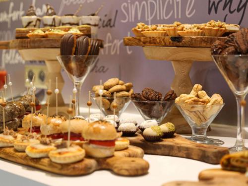 a table filled with different types of pastries and desserts at Ibis Sfax in Sfax