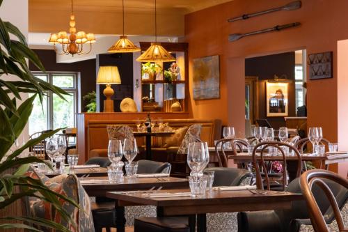 a restaurant with tables and chairs with wine glasses at The Ropemaker - A Heartwood Inn in Emsworth