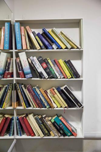 a book shelf filled with lots of books at Tempi Hotel in Athens