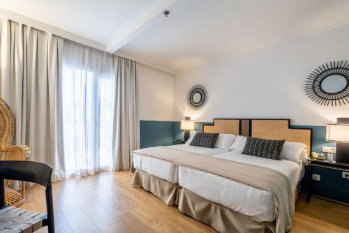 a bedroom with a large bed and a large window at Soho Boutique Las Vegas in Málaga