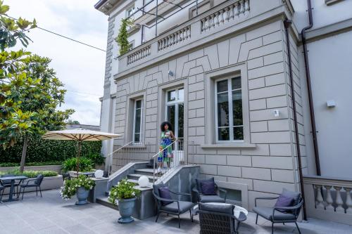 a girl standing on the stairs of a building at Dimora Palanca Boutique & SPA in Florence
