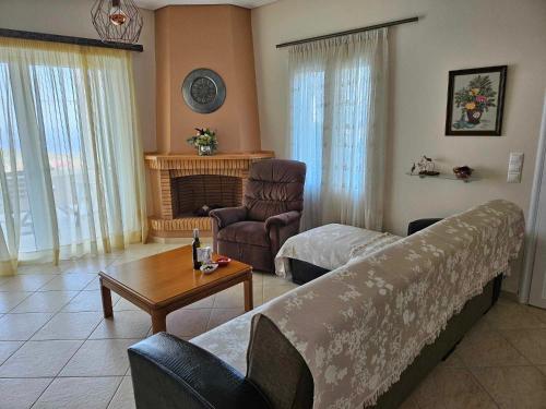 a living room with a couch and a table at Alexandra's Dreamhouse! in Finikounta