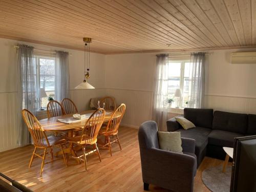 a living room with a table and chairs and a couch at Hus i Lappland in Harads