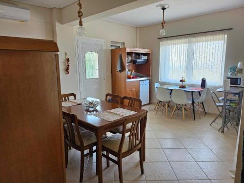 a kitchen and dining room with a table and chairs at Alexandra's Dreamhouse! in Finikounta