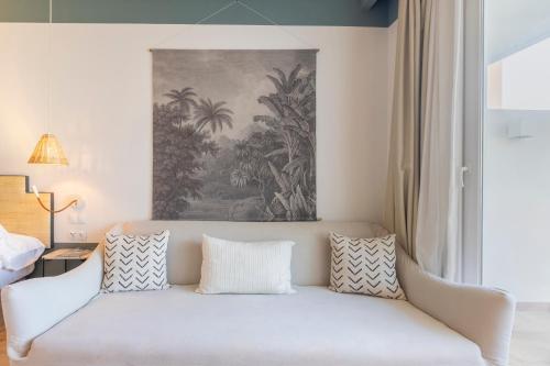 a white couch in a living room with a painting at Soho Boutique Las Vegas in Málaga