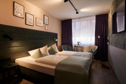 Postel nebo postele na pokoji v ubytování Hotel Mirabell by Maier Privathotels