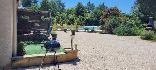 a garden with a blue helmet and a table and chairs at les Versannes in Lamonzie-Montastruc