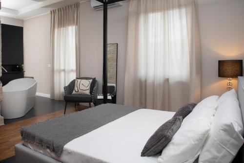 a bedroom with a large bed and a bath tub at Nella Torre Bed & Breakfast in Ascoli Piceno