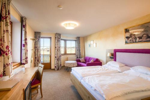 a hotel room with a bed and a desk and a table at Gastagwirt in Eugendorf
