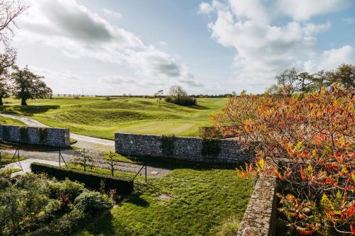 a view of a golf course with a green at Domaine de Naxhelet in Wanze