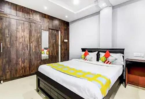 a bedroom with a large bed with a wooden wall at Jubilee Homes in Hyderabad