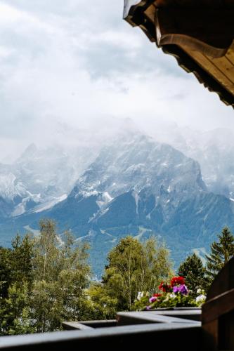 a view of a snow covered mountain from a window at Hotel Klockerhof in Lermoos