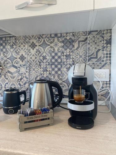 a coffee maker on a counter next to a box of coffee at SEASIDE Bed and Breakfast in Praia a Mare