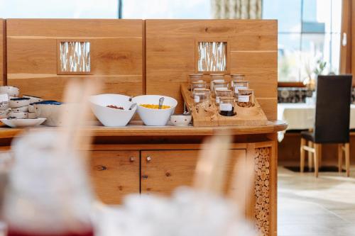 a counter with bowls of food on top of it at Hotel Klockerhof in Lermoos