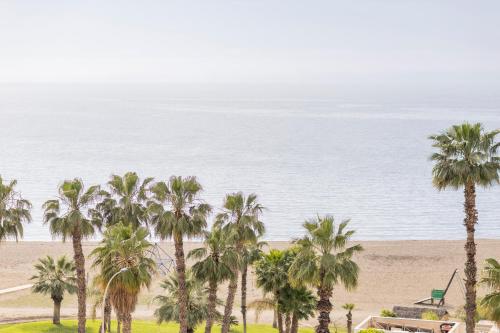 an aerial view of a beach with palm trees at Soho Boutique Las Vegas in Málaga