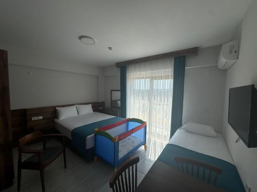 a small bedroom with a bed and a window at Troilus Park House in Eceabat
