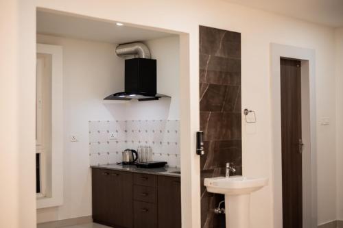 a bathroom with a sink and a counter top at Borail Homes in Silchar