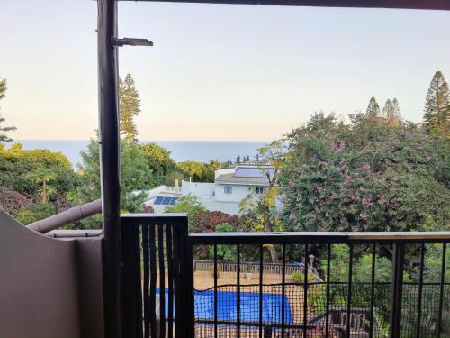 a view of the ocean from the balcony of a house at Upstairs Flat Sea Views Pet Friendly in Ballito