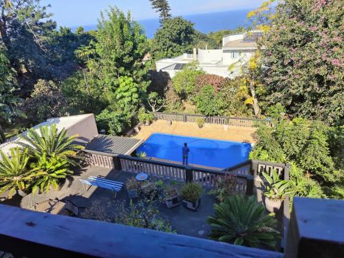 an aerial view of a backyard with a swimming pool and a fence at Upstairs Flat Sea Views Pet Friendly in Ballito