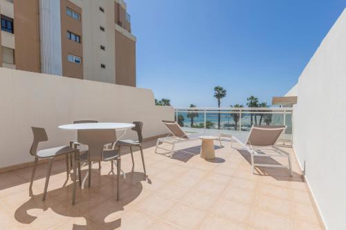 a balcony with a table and chairs on a building at Soho Boutique Las Vegas in Málaga