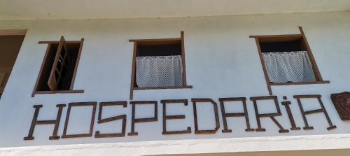 a group of windows on the side of a building at Hospedaria Cosanostra in Itaúnas