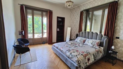 a bedroom with a large bed and a window at Villa Giordana in Casalborgone