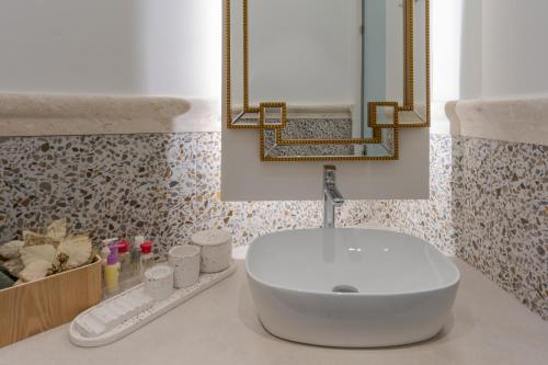 a bathroom with a white sink and a mirror at Studio Sun 365 by Estia in Anissaras