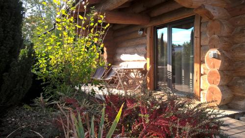 a stone house with a bench in front of a window at Les Chalets de Maramour in Chazey-sur-Ain