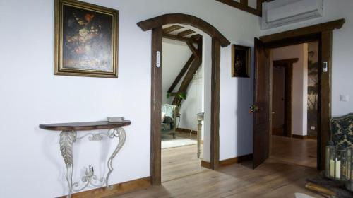 a hallway with a mirror and a table on a wall at Au cœur des prés in Montmort